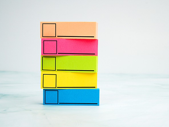 stack of colourful sticky notes with tick-boxes ready to be checked
